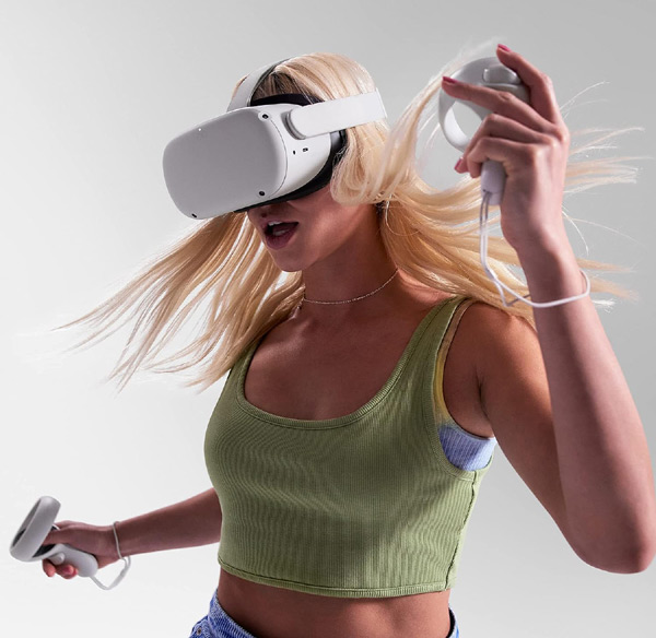 Woman playing with Meta Quest 2 headset in virtual reality