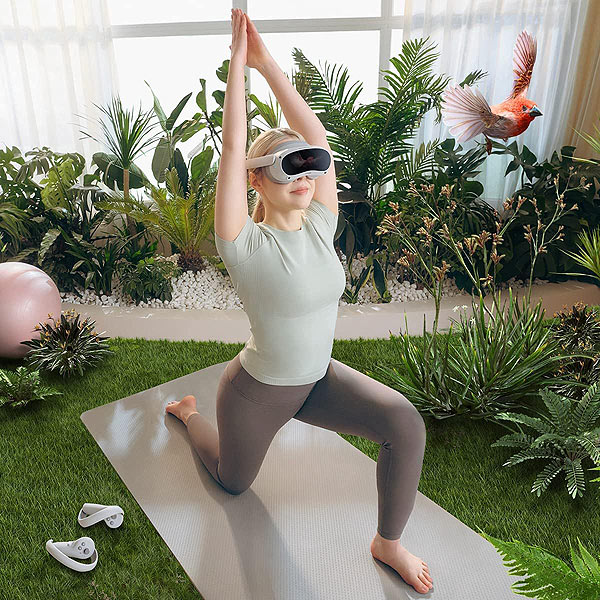 Woman doing yoga with virtual reality headset